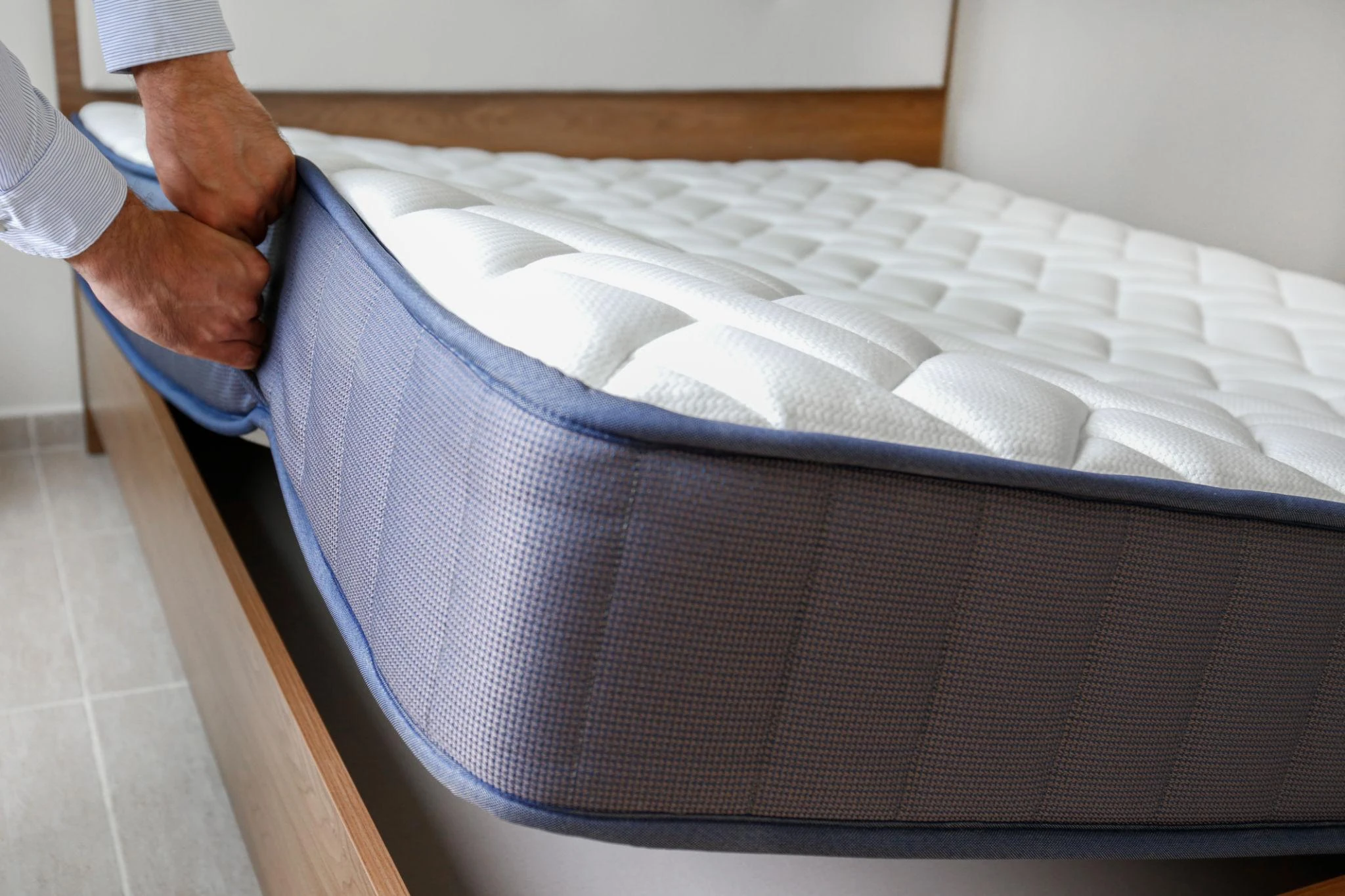 Detalle de colchón viscoelástico y base tapizada en dormitorio moderno en Barcelona